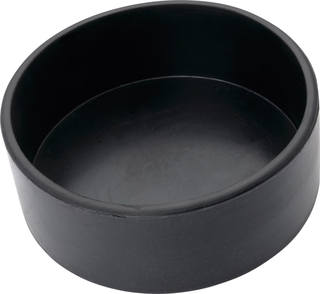 Pajarito_Dummy_Plaster cup cylindr Form rubber_038495_037186_2021-02 A round black rubber end cap or protective plug with a shallow cylindrical, cup-like shape, smooth matte surface with faint scuff marks, photographed from a top-side angle on a white background.