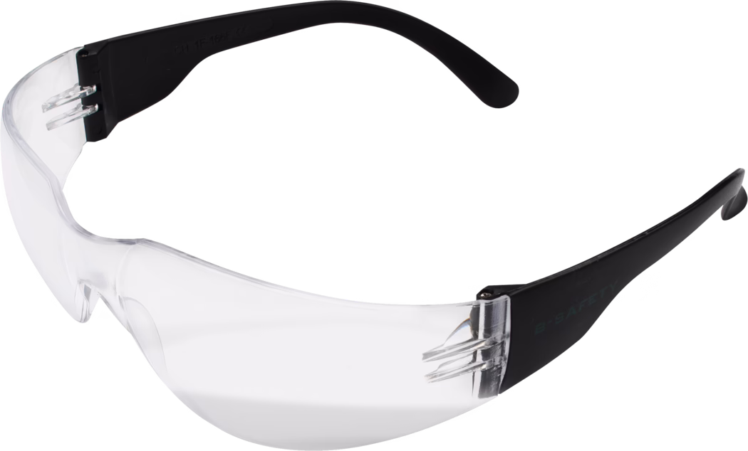 Lunettes de sécurité enveloppantes transparentes avec une unique lentille incurvée transparente et des branches noires. La lentille monobloc offre une large protection et un pont nasal intégré ; les branches sont fines, légèrement courbées et noires, avec de petits rivets métalliques aux charnières. Lunettes de protection légères adaptées à la protection générale des yeux contre la poussière, les particules volantes et les éclaboussures légères lors de bricolage, en atelier ou en laboratoire.