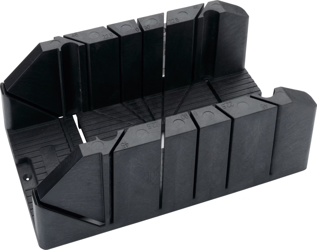 Boîte à coupe en plastique noire conçue pour guider une scie à main et réaliser des coupes d'angle précises. L'outil monobloc moulé comporte plusieurs fentes verticales marquées d'angles courants (45°, 22,5°, 90°), une base rainurée pour stabiliser la pièce, des parois renforcées et des trous de fixation pour le fixer à un établi. Les marquages d'angle visibles et les largeurs de fente variées conviennent aux coupes en onglet et traversales sur moulures, baguettes, chevilles et petites pièces de bois.